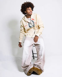 Person wearing FABL3 Sade Thermal Zipup sitting on a stool against a white background